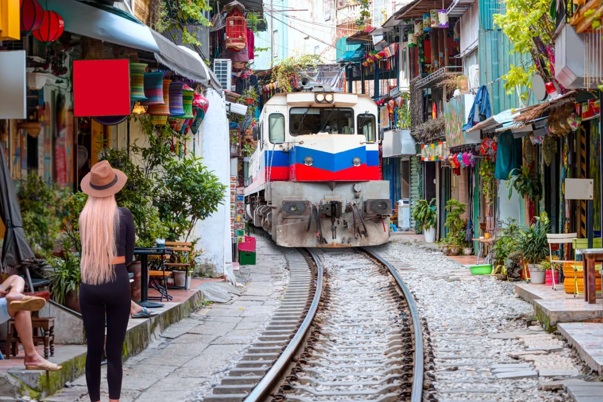 Female tourist visiting famous Train Street in Hanoi