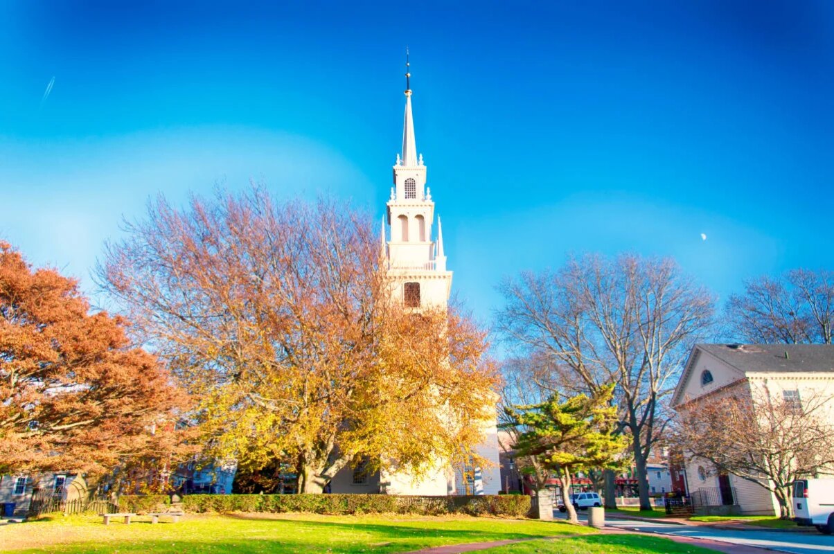 The landmark trinity church in Queen Anne Square in late autumn in Newport Rhode Island.